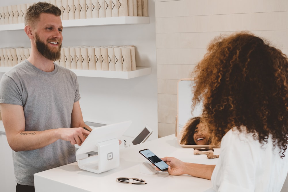 Customer paying with phone at a retail counter
